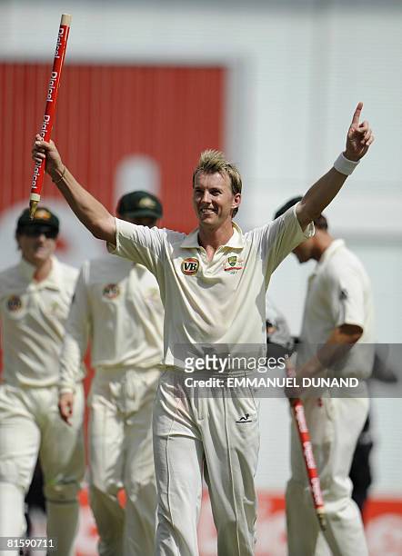 Australian bowler Brett Lee raises a stump in celebration of Australia's victory over the West Indies, at the end of the fifth and last day of the...