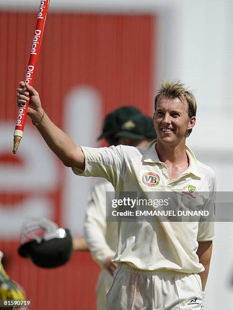 Australian bowler Brett Lee raises a stump in celebration of Australia's victory over the West Indies, at the end of the fifth and last day of the...