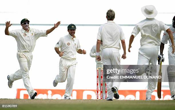 Australian players celebrate their victory over the West Indies at the end of the fifth and last day of the third test match between the West Indies...