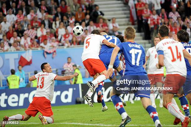 Polish midfielder Dariusz Dudka and Croatian forward Mladen Petric jump fpr the ball during the Euro 2008 Championships Group B football match Poland...