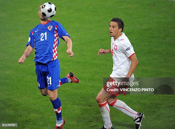 Croatian forward Mladen Petric vies for the ball with Polish midfielder Dariusz Dudka during the Euro 2008 Championships Group B football match...