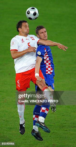 Polish midfielder Dariusz Dudka jumps for the ball with Croatian forward Ivan Klasnic during the Euro 2008 Championships Group B football match...