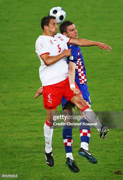 Dariusz Dudka of Poland jumps for a header with Ivan Klasnic of Croatia during the UEFA EURO 2008 Group B match between Poland and Croatia at...