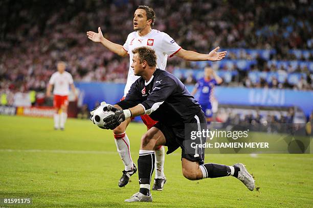 Polish goalkeeper Artur Boruc grabs the ball in front of Polish midfielder Dariusz Dudka during the final Euro 2008 Championships Group B football...