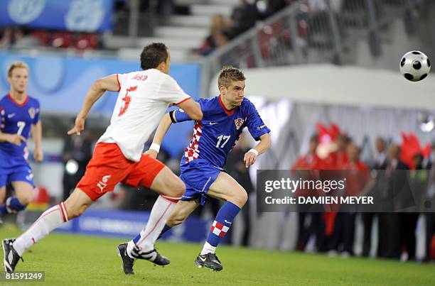 Polish midfielder Dariusz Dudka vies with Croatian forward Ivan Klasnic during the final Euro 2008 Championships Group B football match Poland vs....