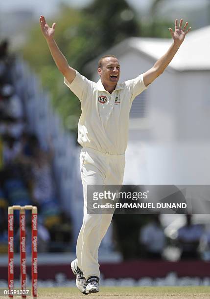 Australian bowler Stuart Clark celebrates after taking the wicket of West Indies' batsman Denesh Ramdin, during the fifth and last day of the third...