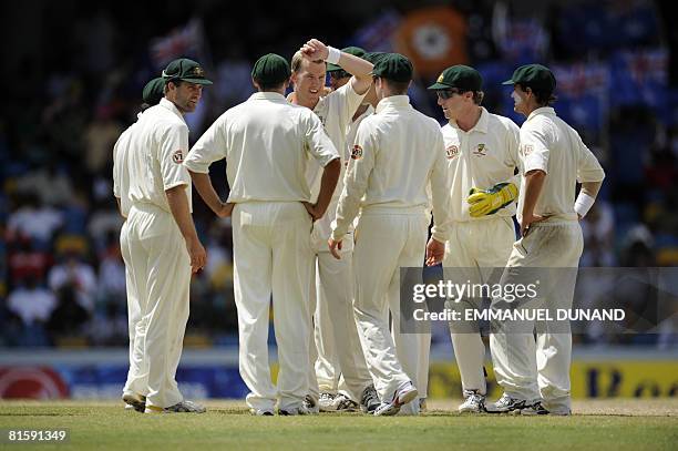 Australian bowler Brett Lee celebrates with teammates after taking the wicket of West Indies' batsman Sewnarine Chattergoon , during the fifth and...