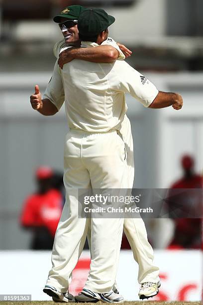 Michael Hussey of Australia embraces captain Ricky Ponting after defeating the West Indies during day five of the third test match between the West...