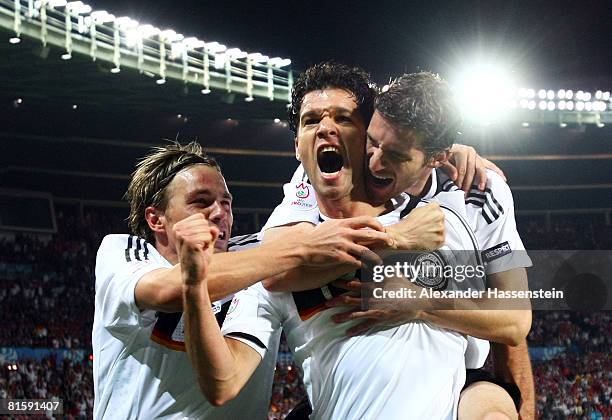 Michael Ballack of Germany celebrates with team mates Clemens Fritz and Arne Friedrich after scoring the opening goal during the UEFA EURO 2008 Group...