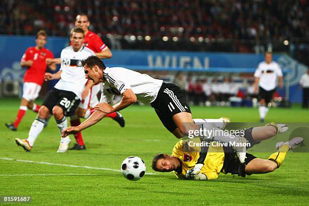 Miroslav Klose of Germany is tackled by goalkeeper Juergen Macho of Austria during the UEFA EURO 2008 Group B match between Austria and Germany at...
