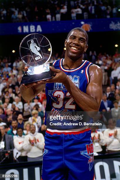 Magic Johnson of the Western Conference All-Stars holds the MVP trophy following the 1992 NBA All Star Game on February 9, 1992 at the Orlando Arena...