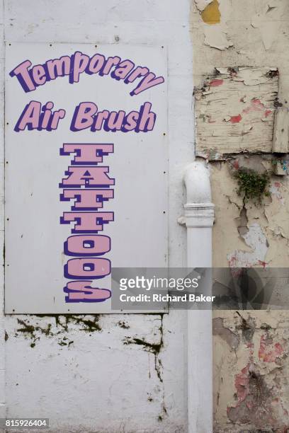 Detail of a sign outside a seaside trinket shop selling temporary tattoos, on 14th July 2017, at Scarborough, North Yorkshire, England.