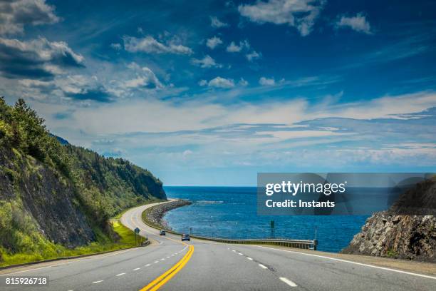 right by the saint lawrence river, a look at beautiful quebec route 132, near cap-au renard (la martre) in haute-gaspésie, situated in the eastern part of the canadian province. - gaspe quebec stock pictures, royalty-free photos & images
