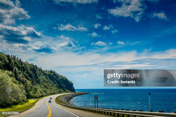 right by the saint lawrence river, a look at beautiful quebec route 132, near cap-au renard (la martre) in haute-gaspésie, situated in the eastern part of the canadian province. - quebec road stock pictures, royalty-free photos & images