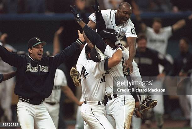 Baseball: AL playoffs, Seattle Mariners Ken Griffey Jr, victorious with Alex Rodriguez and team after scoring game and series winning run vs New York...