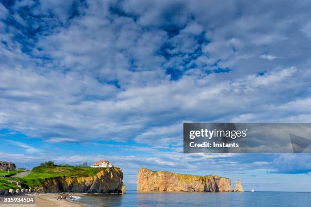 a look at the famous rocher percé (perce rock), part of the gaspé peninsula in the canadian province of québec. - perce rock stock pictures, royalty-free photos & images
