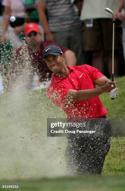 Tiger Woods pitches out of a sandtrap as he takes his third shot on the ninth hole during the playoff round of the 108th U.S. Open at the Torrey...