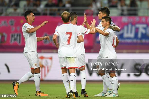 Wissam Ben Yedder of Sevilla FC celebrates with his team mates after scoring on a penalty kick during the preseason friendly match between Cerezo...