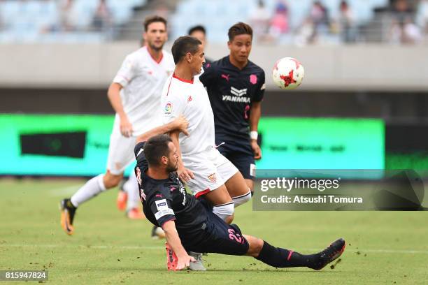 Wissam Ben Yedder of Sevilla FC is tackled by Matej Jonjic of Cerezo Osaka during the preseason friendly match between Cerezo Osaka and Sevilla FC at...