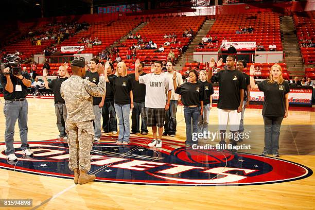 The US Army's newest recruits swear in before the game between the Atlanta Dream and the Houston Comets at Reliant Arena on June 16, 2008 in Houston,...