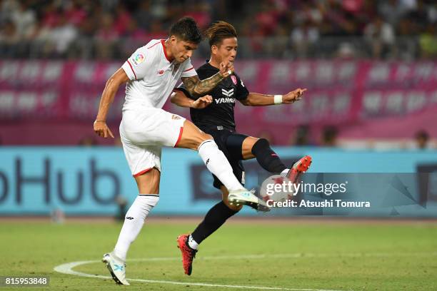 Joaquin Correa of Sevilla FC and Riku Matsuda of Cerezo Osaka compete for the ball during the preseason friendly match between Cerezo Osaka and...