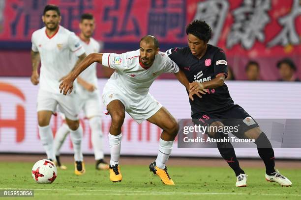 Guido Pizarro of Sevilla FC controls the ball against Ryuji Sawakami of Cerezo Osaka during the preseason friendly match between Cerezo Osaka and...