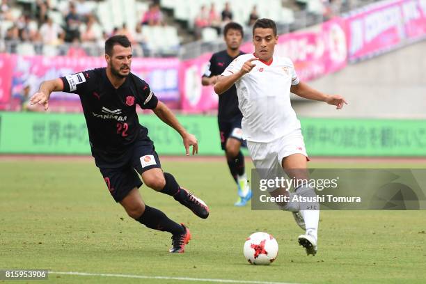 Wissam Ben Yedder of Sevilla FC and Matej Jonjic of Cerezo Osaka compete for the ball during the preseason friendly match between Cerezo Osaka and...