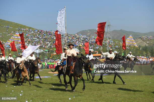 People riding horse perform during The 18th China nine color Gannan the Shambhala Tourism Arts Festival at Hezuo on July 17, in Gannan Tibetan...