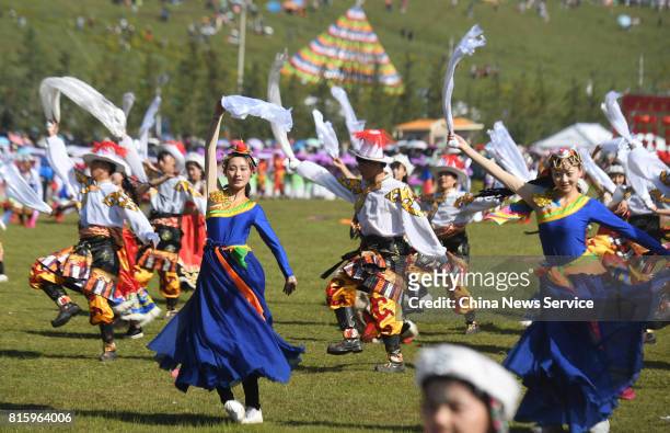 People perform Guozhuang dance during The 18th China nine color Gannan the Shambhala Tourism Arts Festival at Hezuo on July 17, in Gannan Tibetan...