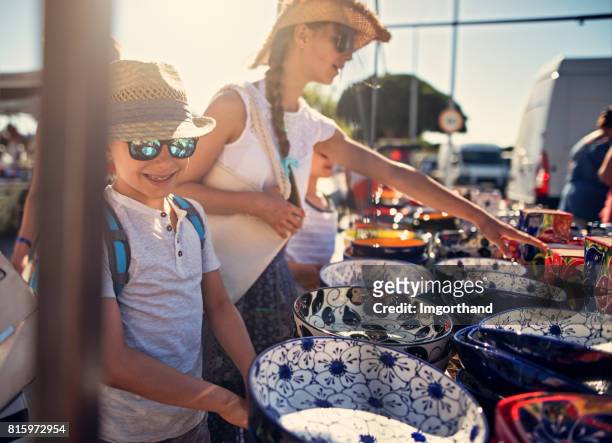 kids buying souvenirs on flea market in andalusia, spain - craft product stock pictures, royalty-free photos & images