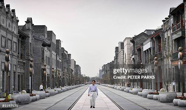 Visitor walks down a once historical street that belongs to Beijing's oldest neighbourhoods but has now been turned into the city's newest tourist...