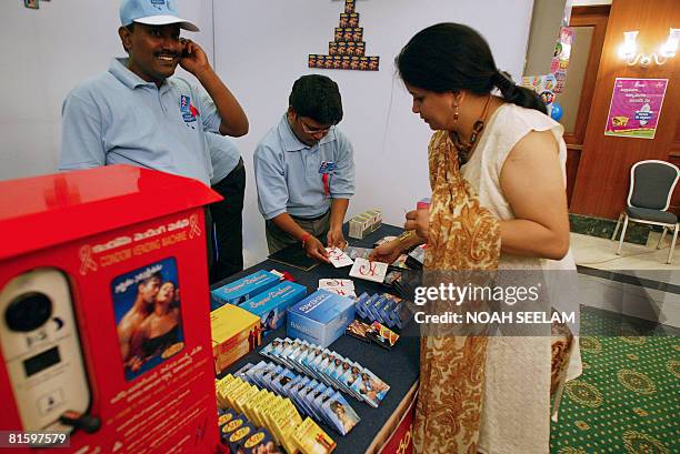 An Indian woman cheks female condoms during a promotion programme called "Do You Have It" in Hyderabad, on June 17, 2008. The programme is aimed at...