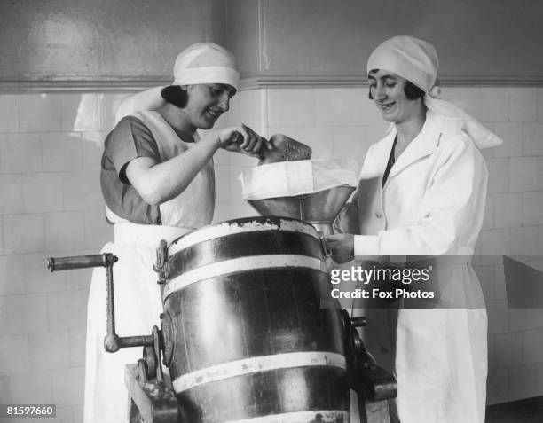 Dairymaids at work making butter on King's Farm, Frogmore near Windsor, Berkshire, circa 1935.