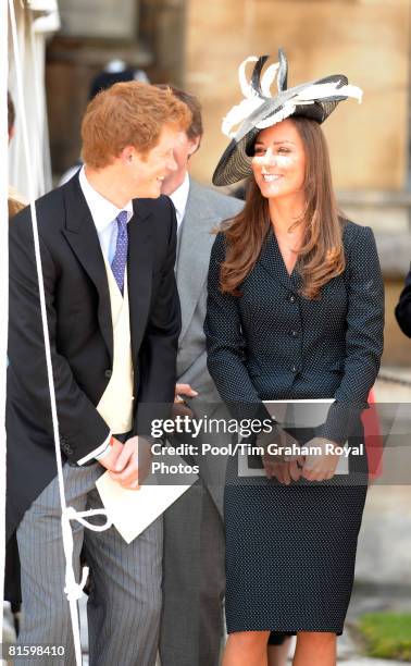 Prince Harry and Prince William's girlfriend Kate Middleton laugh together as they watch the Order of the Garter procession at Windsor Castle on June...