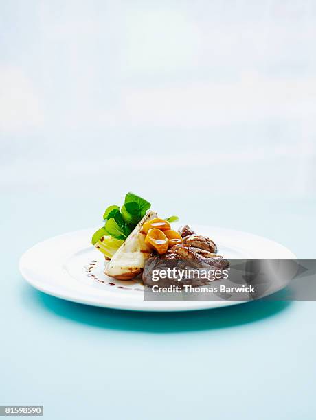 crisp liberty duck breast, braised endive, watercress and grilled pears.  - food plate stock pictures, royalty-free photos & images