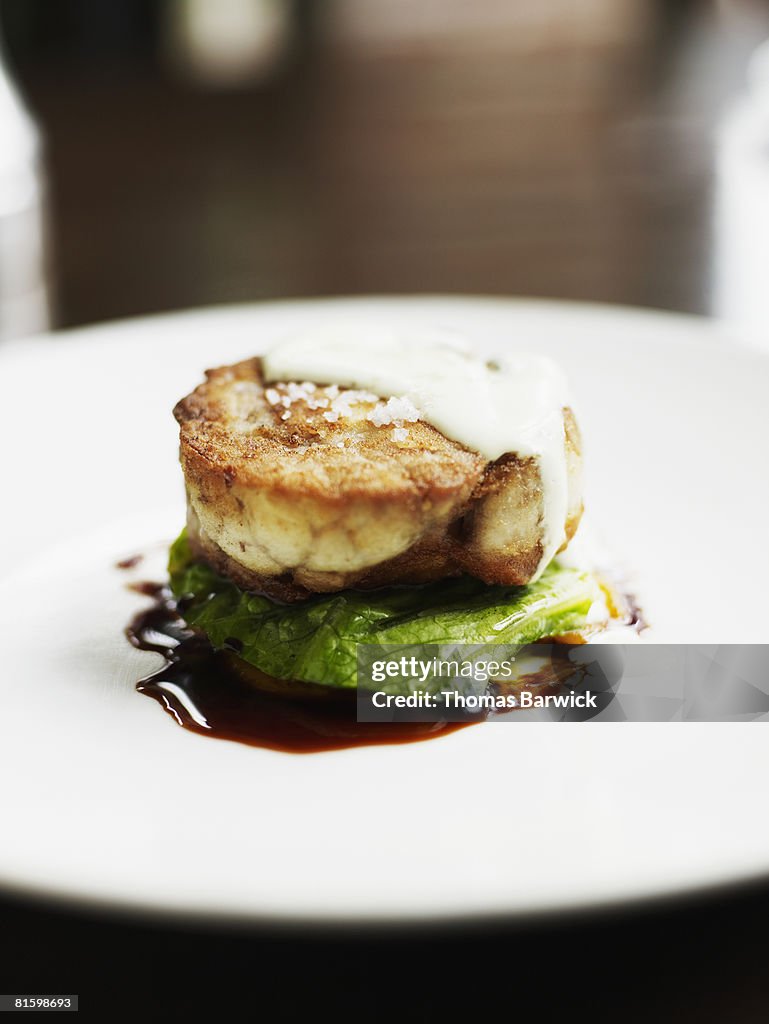 Roulade of veal sweetbreads and chicken mousse with fried green tomato, apricot puree, romaine and egg sauce