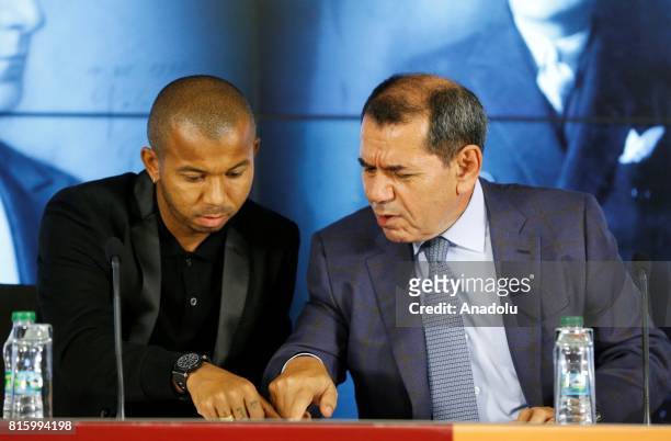 Galatasaray's new transfer Mariano Ferreira Filho signs a contract as Galatasaray's President Dursun Ozbek stand near him during the signing ceremony...