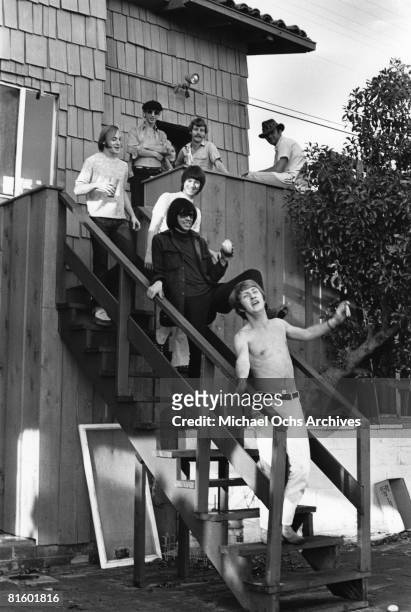 Superstar group "Buffalo Springfield" pose for a portrait with two unidentified men on the steps of their house on October 30, 1967 in Malibu,...