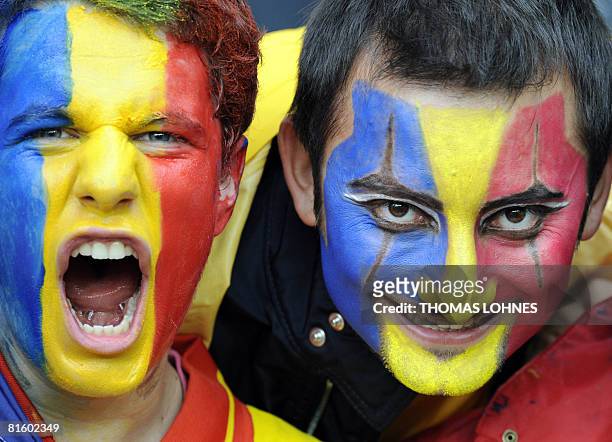 Two supporters of the Romanian team cheer in the stands before the Euro 2008 Championships Group C football match Netherlands vs. Romania on June 17,...