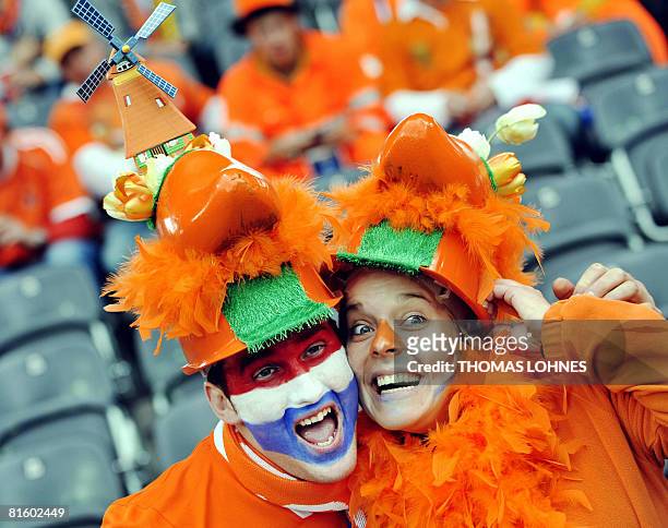 Two supporters of the Dutch team cheer in the stands before the Euro 2008 Championships Group C football match Netherlands vs. Romania on June 17,...
