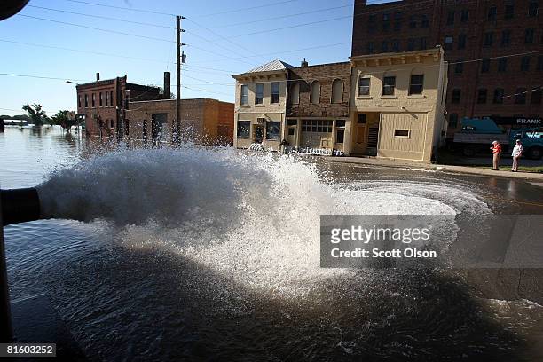 Water is pumped to the street from the LaMont Ltd. Warehouse June 17, 2008 in Burlington, Iowa. Communities along the Mississippi River in Iowa,...