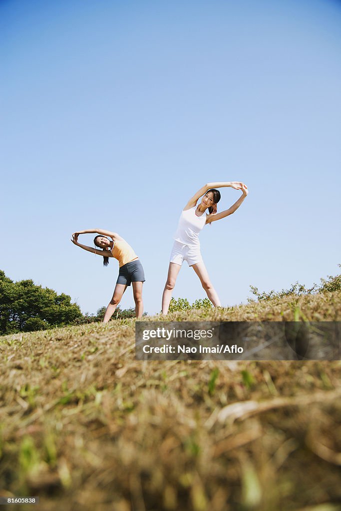 Two Young Women Stretching