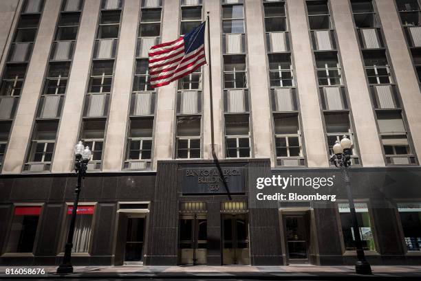 An American flag flies outside a Bank of America Corp. Building in Chicago, Illinois, U.S., on Sunday, July 9, 2017. Bank Of America Corp. Is...