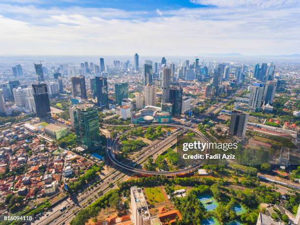 jakarta's new icon, semanggi overpass, in a super bright day - zuidoost azië stockfoto's en -beelden