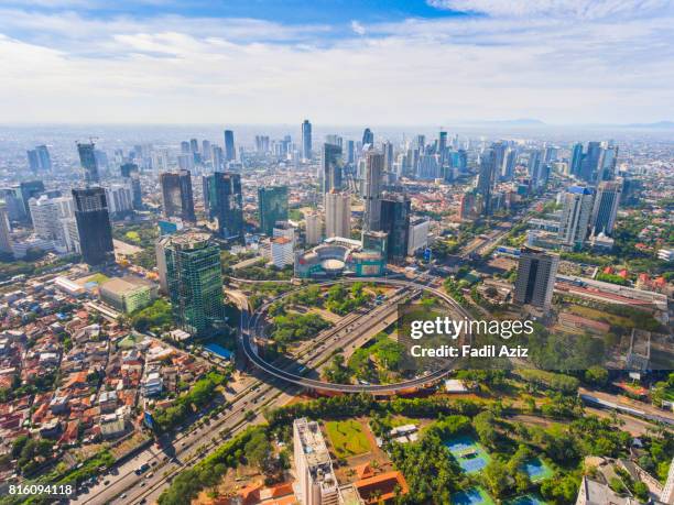 jakarta's new icon, semanggi overpass, in a super bright day - indonesië stockfoto's en -beelden