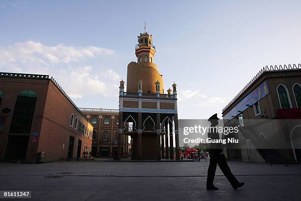 Chinese policeman patrols the Id Kashgar Square, venue for the opening ceremony for the Xinjiang Province leg of the 2008 Beijing Olympic Games torch...