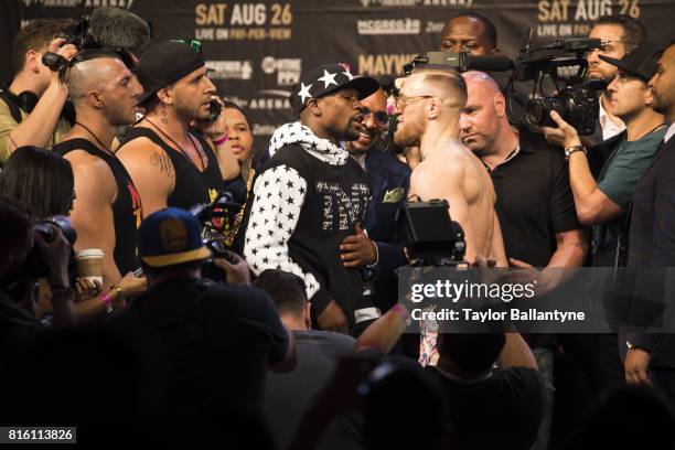 Floyd Mayweather Jr. And Conor McGregor on stage to promote their upcoming Super Welterweight fight during New York leg of press tour at Barclays...