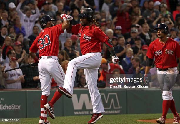 Boston Red Sox designated hitter Hanley Ramirez celebrates with Boston Red Sox left fielder Chris Young after his two-run home run in the third...