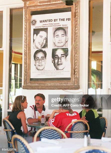 Diners at the Edgewater Hotel on Miami Beach sit under a large wanted poster of Andrew Cunanan 23 July. Cunanan is wanted for the 15 July killing of...