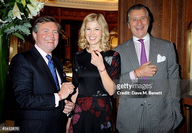 Paul Wilson, CEO of Action Against Hunger, actress Rosamund Pike and Arnaud Bamberger, MD of Cartier UK pose to launch the the Cartier Love Charity...